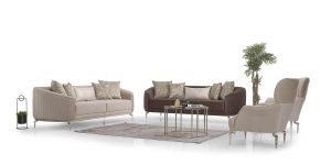 Set canapele ADEN cu design minimalist, picioare metalice înalte argintii/aurii și perne decorative, în showroom-ul Ferremo.